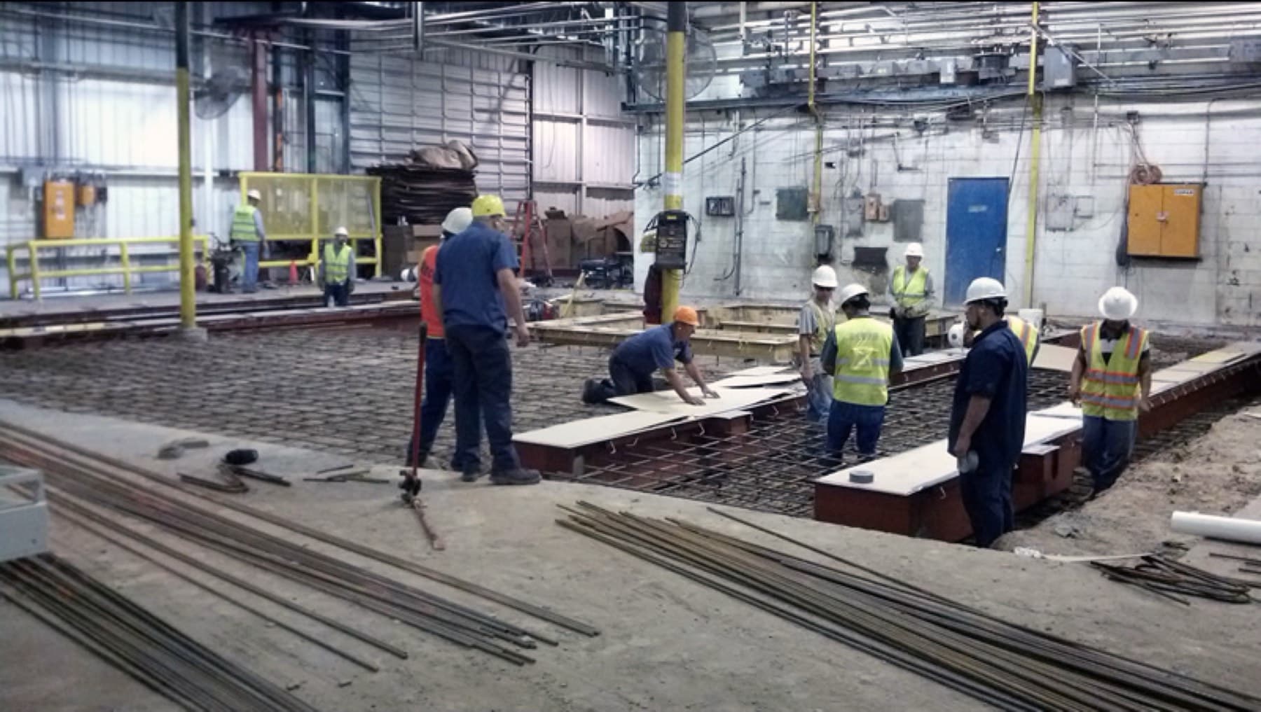 Formwork and reinforcing set beneath a corrugator pre-feeder before the pour