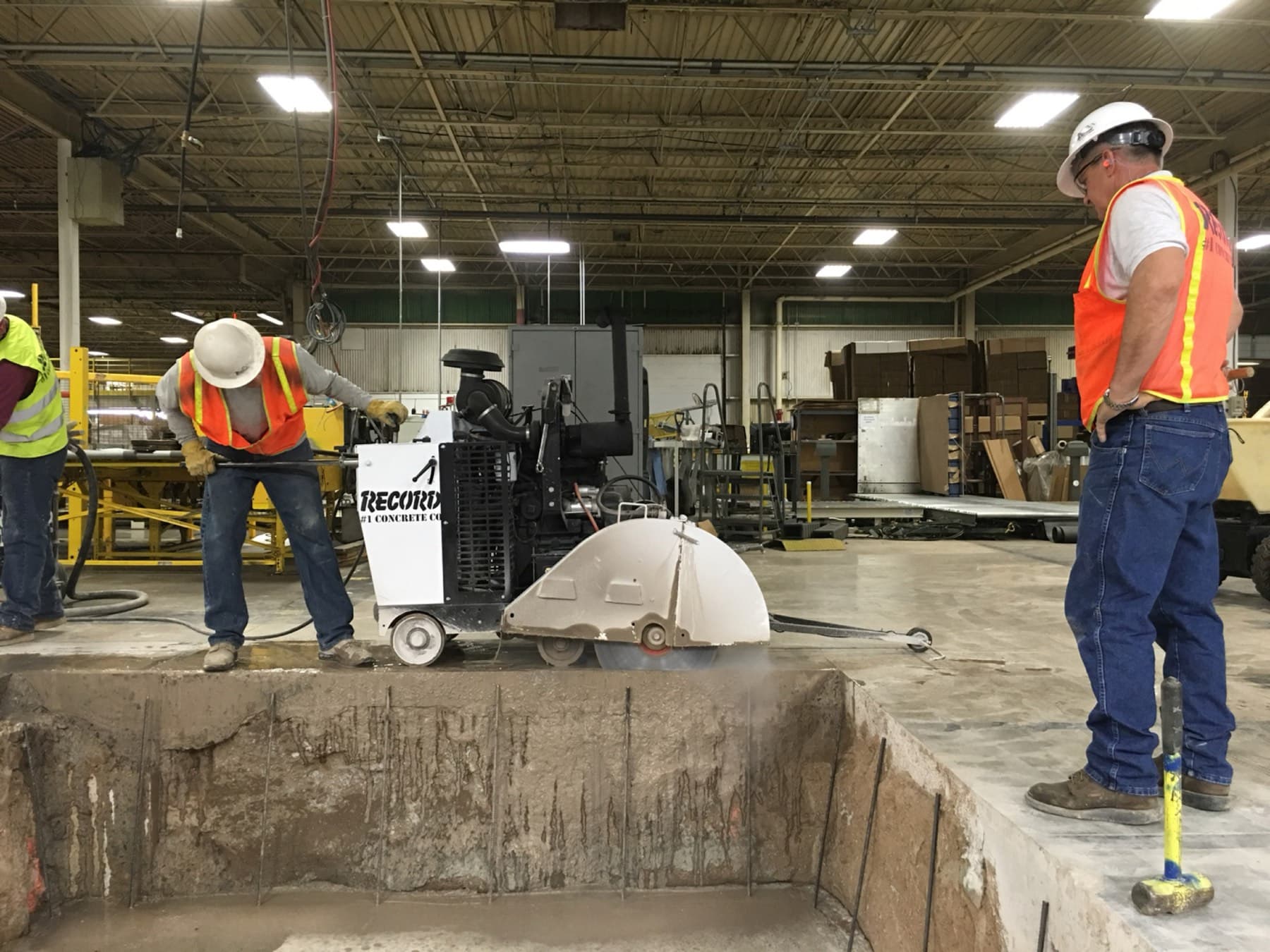 Saw cutting alongside an open equipment pit